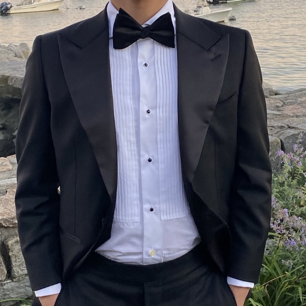 Tuxedo jacket, trousers, and shirt (with black studs)